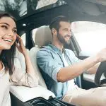 Travelers couple with rental car