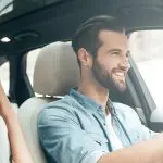 handsome couple in rented car smiling