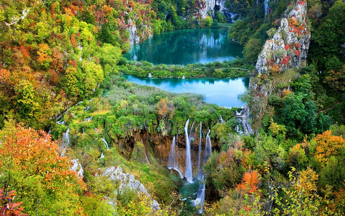 Scenic autumn valley landscape with lakes and waterfall in the mountains of Plitvice Lakes National Park, Croatia.