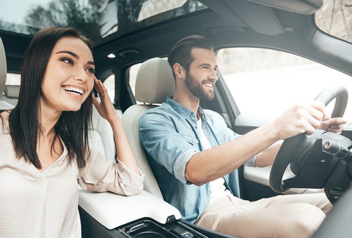 Travelers couple with rental car