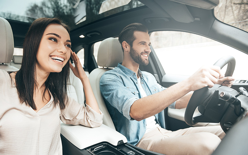 Travelers couple with rental car