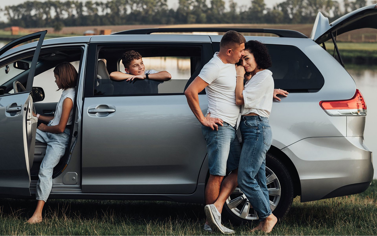 family preparing for a road trip with spacious 6 seater car hire and open sliding door