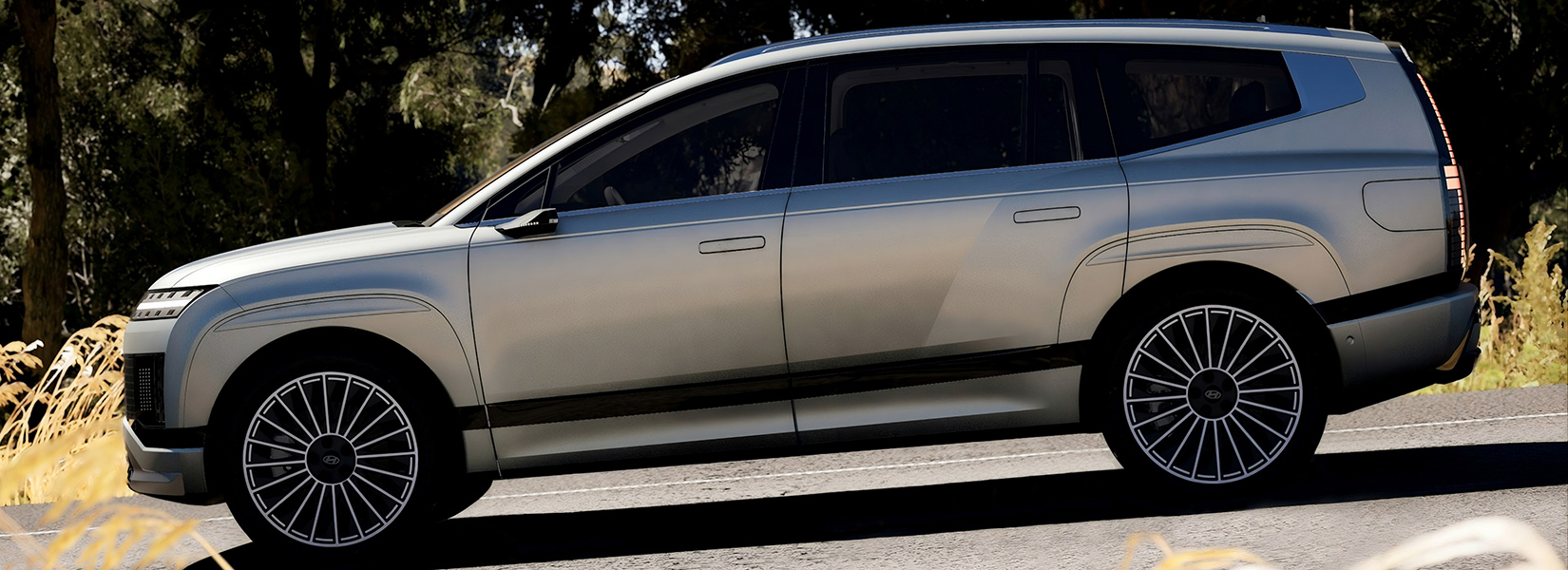 large multi-passenger car driving on countryside road with sleek design