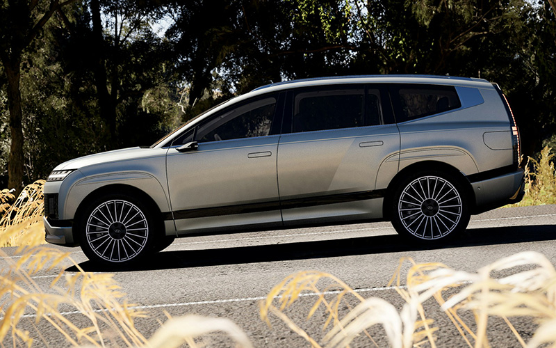 premium 6 seater car hire vehicle driving through nature with large wheels and modern styling