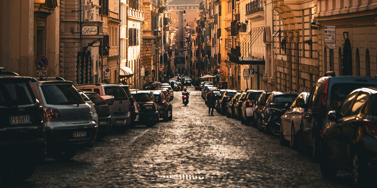 Parking in Italy, vehicles parked in blue-lined parking bays on a city street