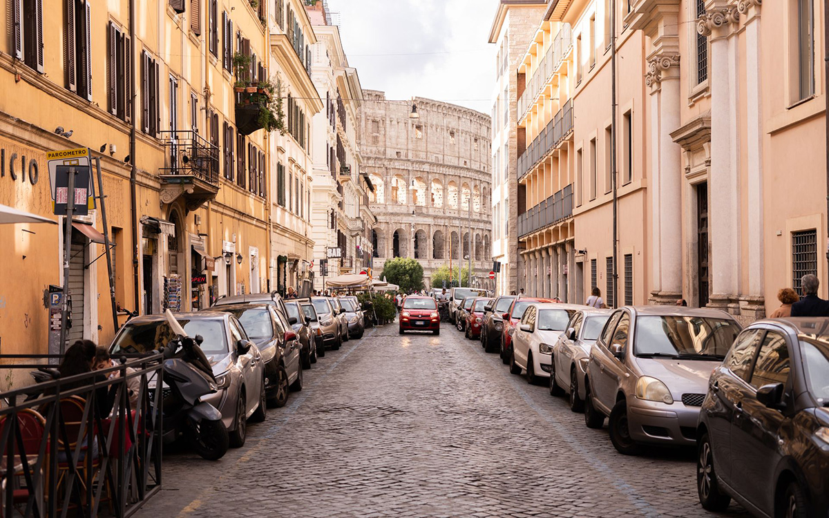 Parking in Rome along a traditional street with the Colosseum visible in the background.