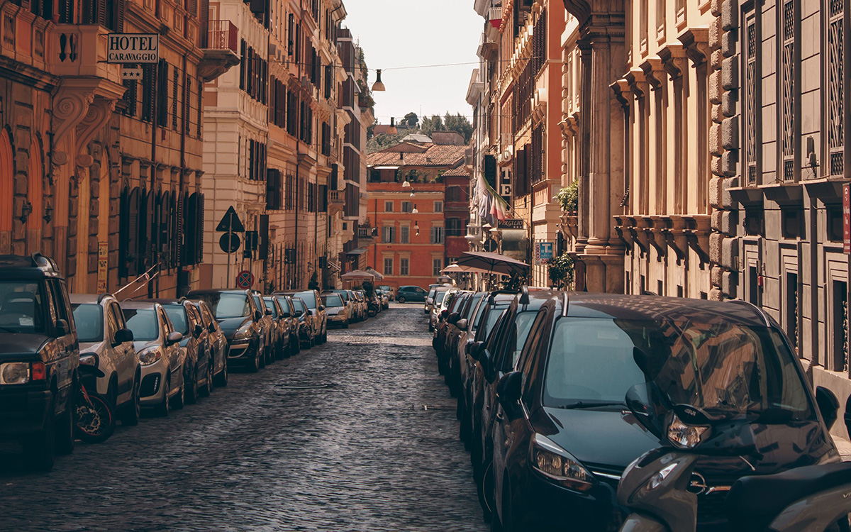 Parking on a picturesque cobblestone street in the heart of the Rome historic centre.