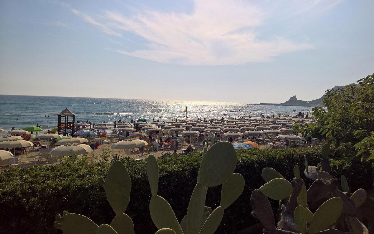 Prickly pears and beach umbrellas on the Sperlonga coast