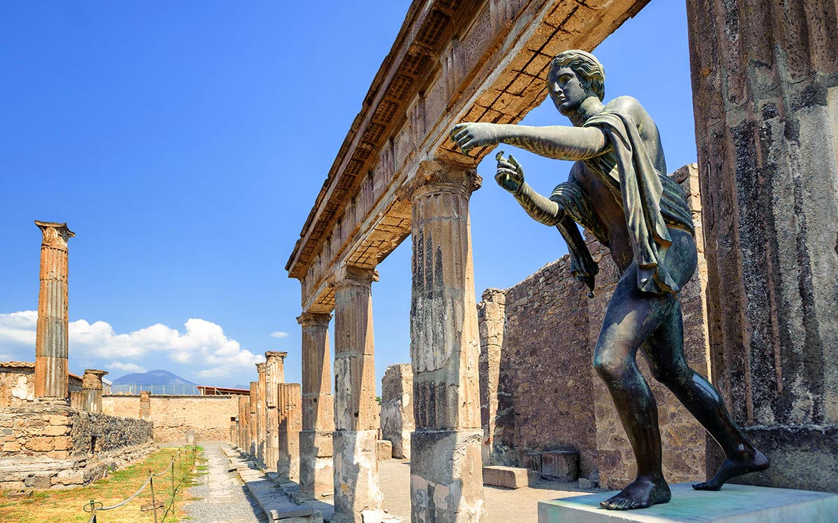 Temple of Apollo ruins and Vesuvius at Pompeii, a popular day trip from Rome
